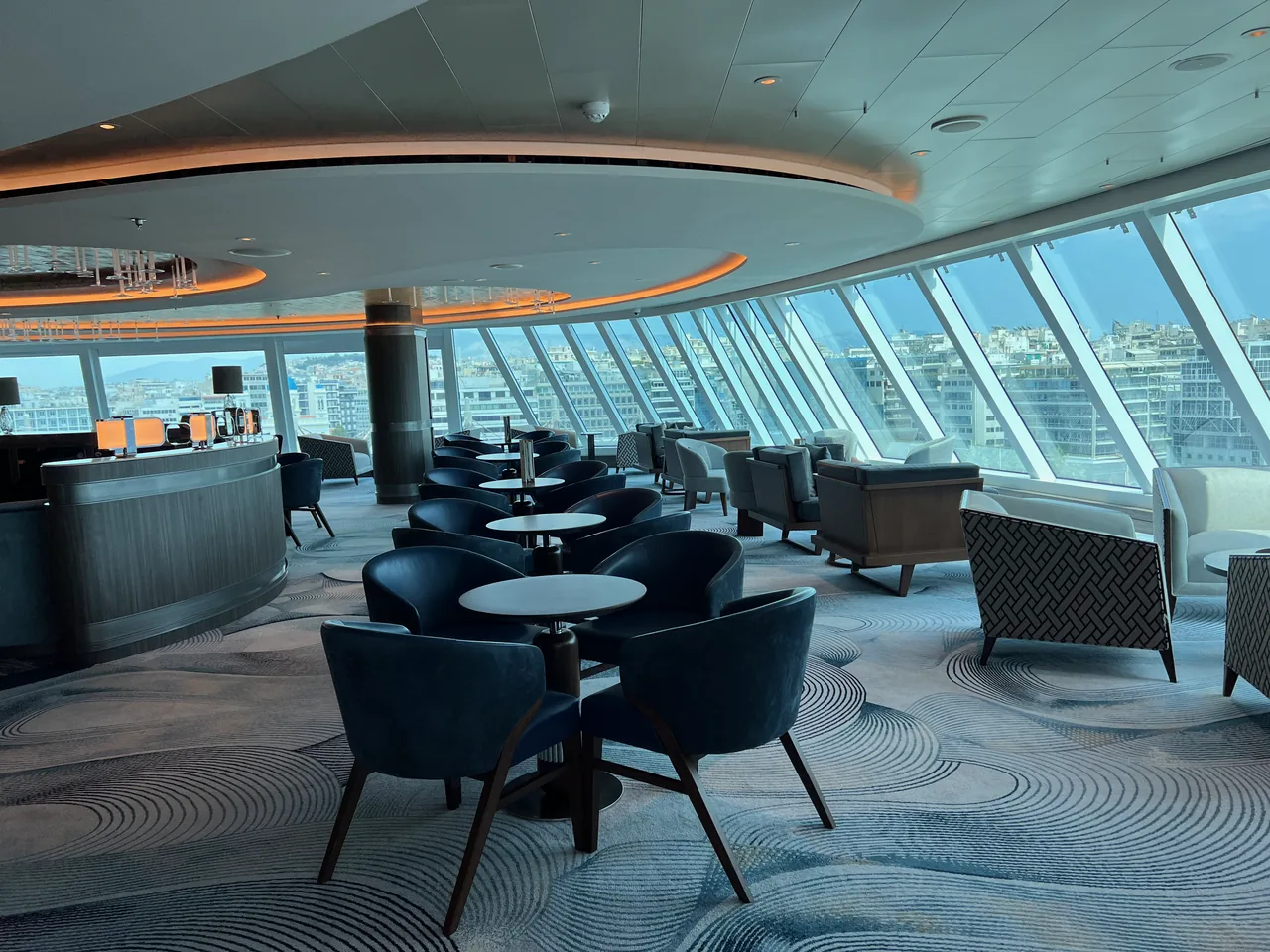 Small tables and seating clusters in Horizons Lounge aboard Oceania Vista