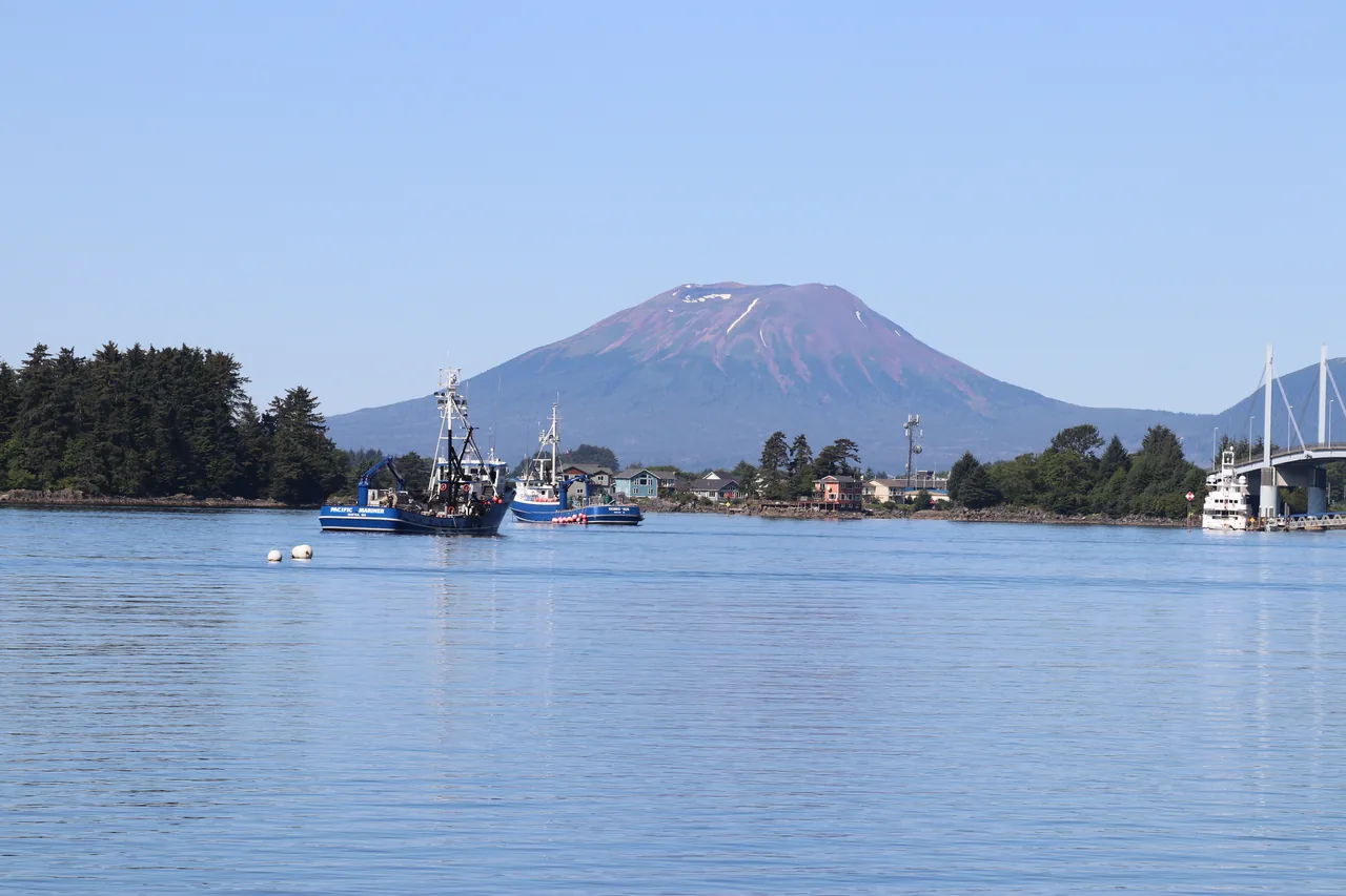 Fishing boats on Sitka Sound with Mount Edgecumbe behind them and part of the John O'Connell Bridge to the right