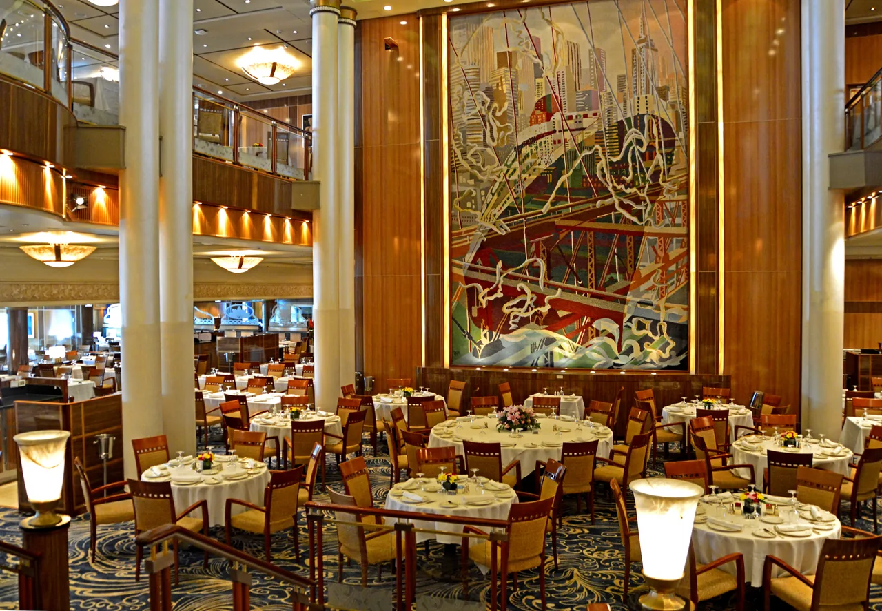 Round tables set for dining in the Britannia Restaurant aboard Queen Mary 2